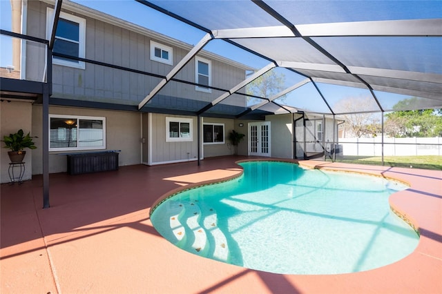 view of swimming pool featuring a patio area, french doors, a lanai, and fence