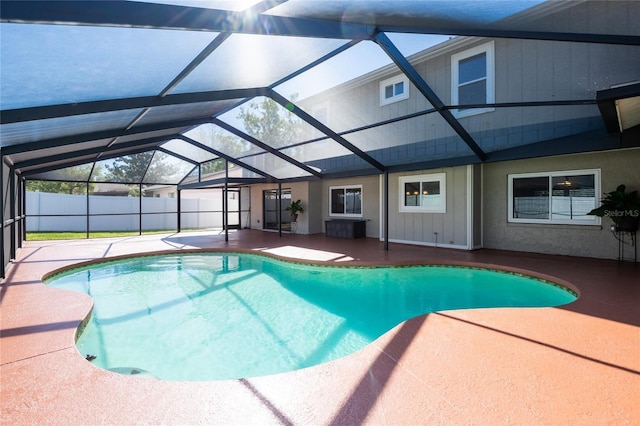 view of pool with a patio area, a fenced in pool, glass enclosure, and fence