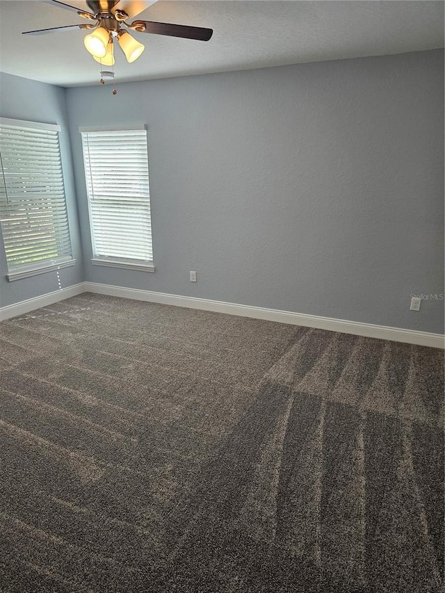 spare room featuring carpet floors, baseboards, and a ceiling fan