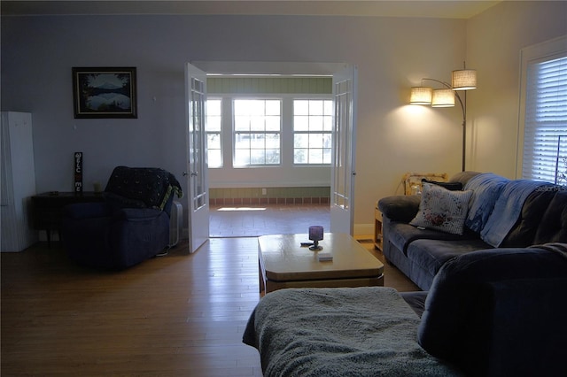 living area with baseboards and wood finished floors