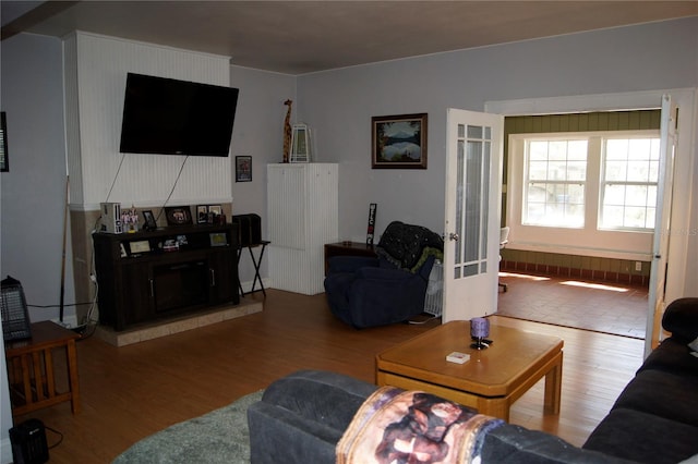 living area with french doors and wood finished floors