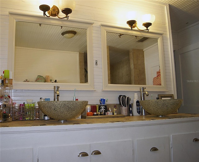 bathroom featuring double vanity and a sink