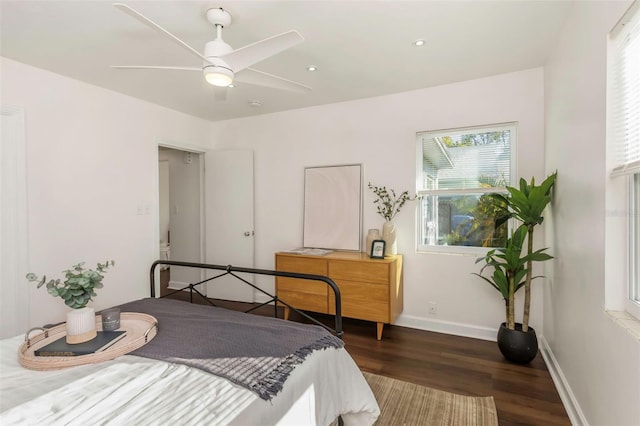 bedroom featuring ceiling fan, wood finished floors, and baseboards