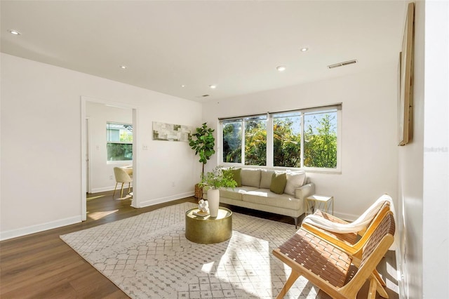 living area with recessed lighting, wood finished floors, visible vents, and a healthy amount of sunlight