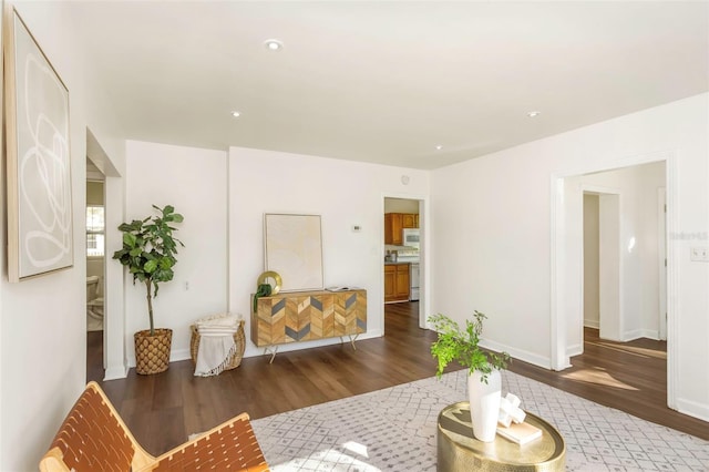 living area featuring baseboards and wood finished floors