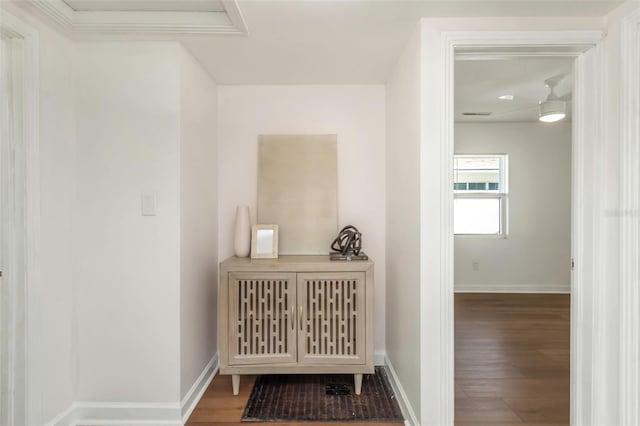 hallway featuring baseboards and wood finished floors