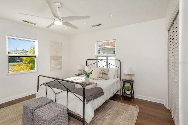 bedroom with recessed lighting, visible vents, baseboards, and wood finished floors