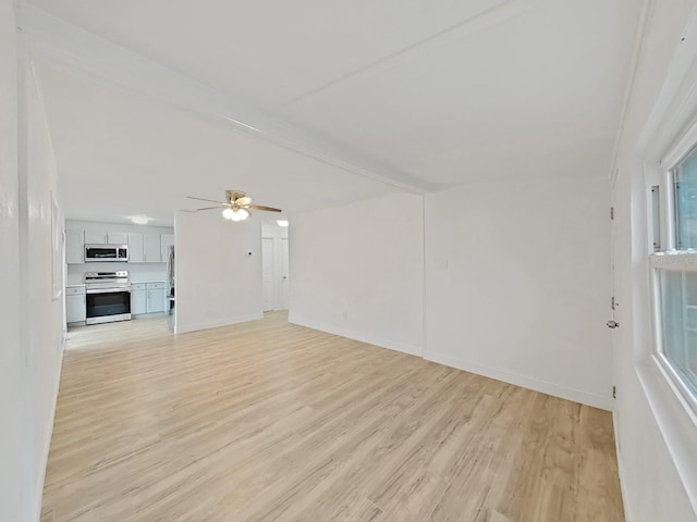 unfurnished living room featuring ceiling fan, light wood-type flooring, beam ceiling, and baseboards