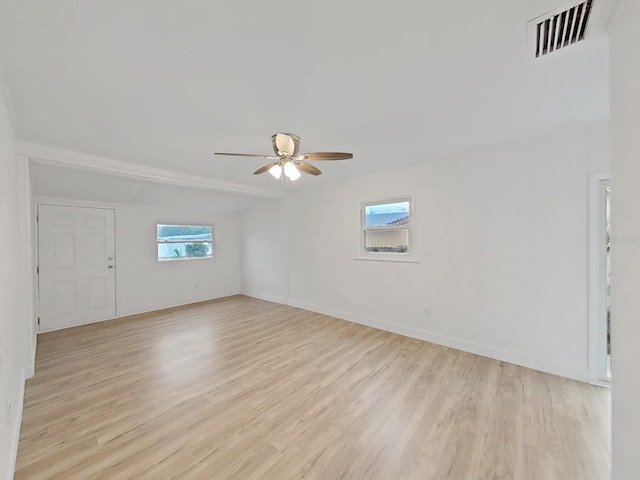 spare room with light wood-style floors, baseboards, visible vents, and a ceiling fan