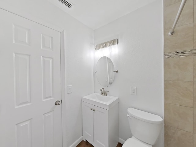 bathroom featuring visible vents, vanity, and toilet