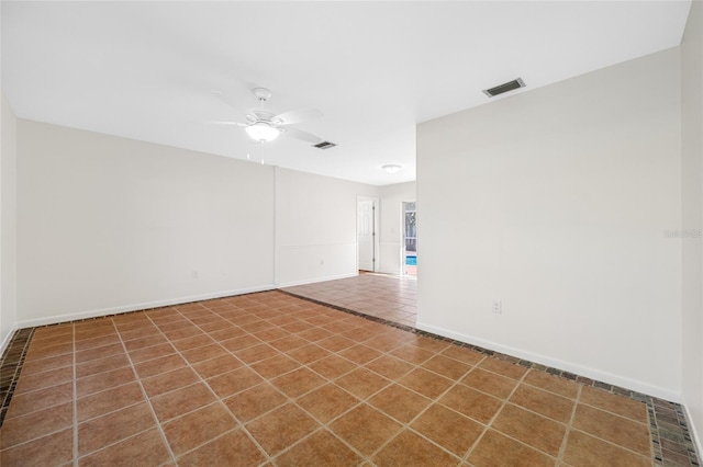 unfurnished room featuring baseboards, a ceiling fan, visible vents, and tile patterned floors