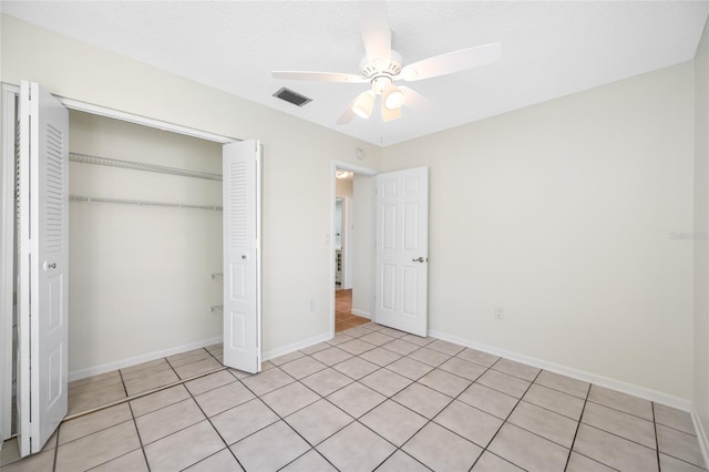 unfurnished bedroom featuring a ceiling fan, a closet, visible vents, and baseboards