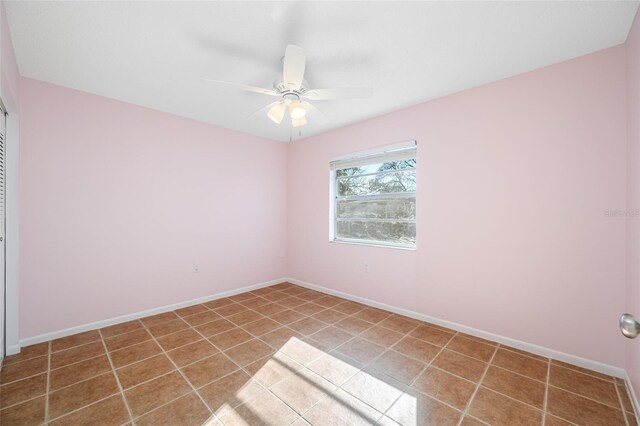 unfurnished room with tile patterned flooring, baseboards, and a ceiling fan