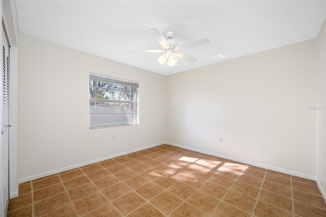 unfurnished bedroom with a closet, ceiling fan, a textured ceiling, and baseboards