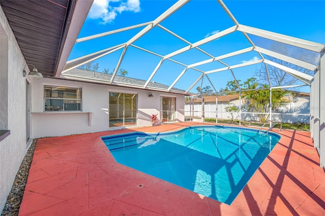 view of pool featuring a patio area, fence, a fenced in pool, and a lanai