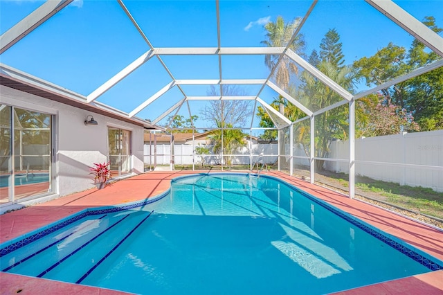 view of pool featuring a lanai, a patio area, a fenced backyard, and a fenced in pool