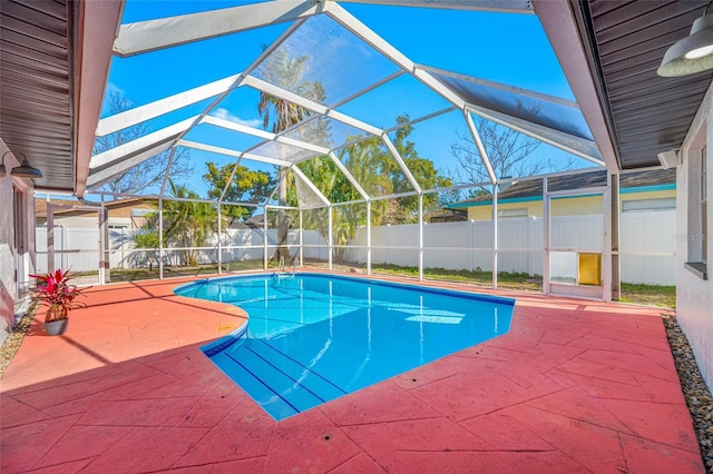 view of swimming pool with a fenced in pool, a lanai, a fenced backyard, and a patio