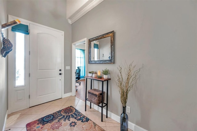 entryway with light tile patterned floors, plenty of natural light, and baseboards