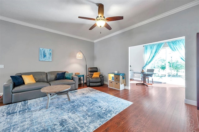 living room with ornamental molding, dark wood finished floors, baseboards, and a ceiling fan