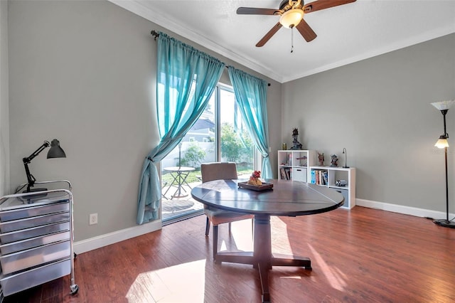 dining area featuring ceiling fan, crown molding, baseboards, and wood finished floors