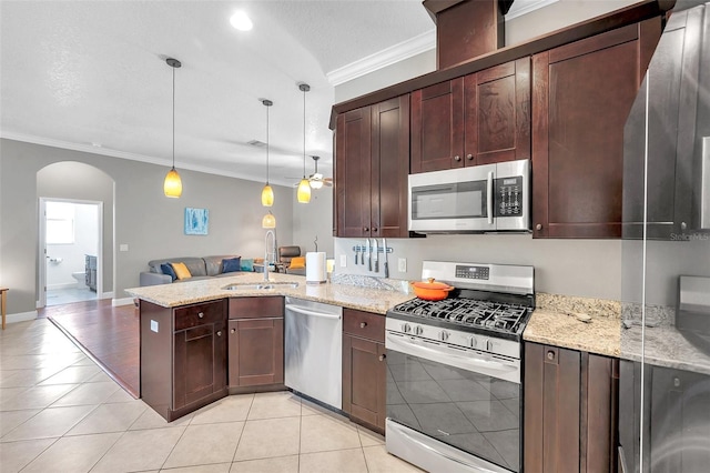 kitchen with arched walkways, crown molding, appliances with stainless steel finishes, a sink, and a peninsula