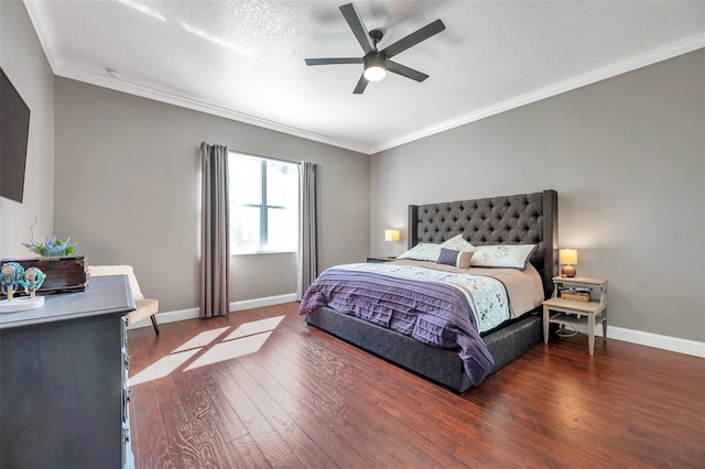 bedroom with ceiling fan, a textured ceiling, wood finished floors, baseboards, and crown molding