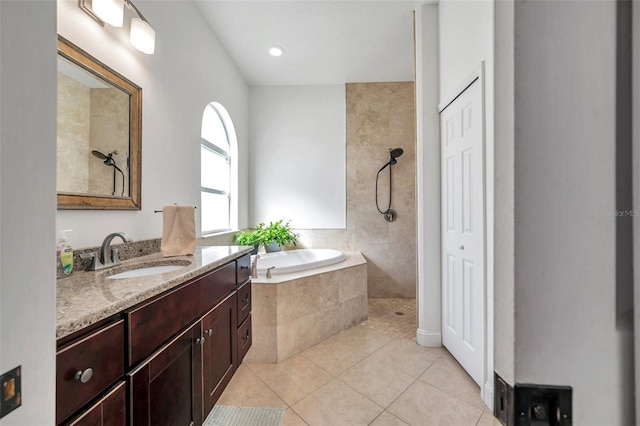 full bath featuring tiled shower, a garden tub, vanity, and tile patterned floors