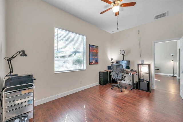 office space with baseboards, visible vents, ceiling fan, and wood finished floors