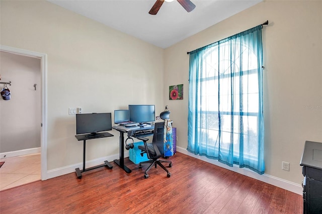 office area featuring baseboards, a ceiling fan, and wood finished floors