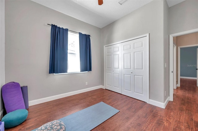 interior space featuring a ceiling fan, baseboards, and wood finished floors