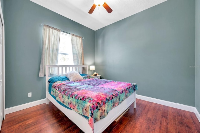 bedroom featuring ceiling fan, baseboards, and wood finished floors