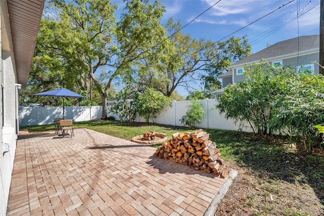 view of patio / terrace with an outdoor fire pit and a fenced backyard