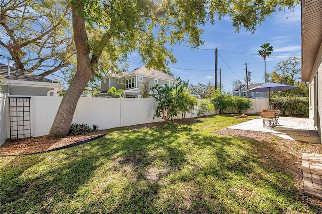 view of yard with a patio area and a fenced backyard