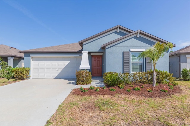 ranch-style home with a garage, driveway, and stucco siding