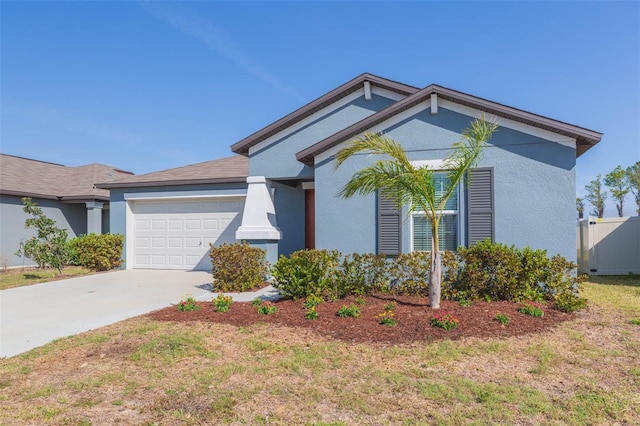 ranch-style home with driveway, an attached garage, and stucco siding