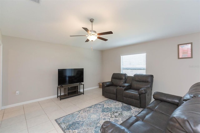 living room featuring light tile patterned flooring, a ceiling fan, and baseboards