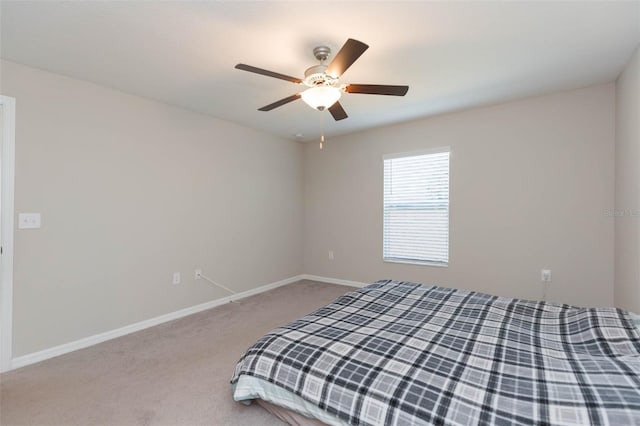 unfurnished bedroom with carpet, ceiling fan, and baseboards