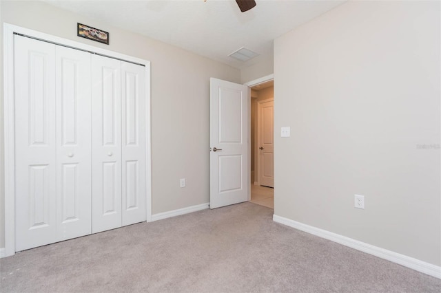 unfurnished bedroom with a ceiling fan, carpet, baseboards, and a closet