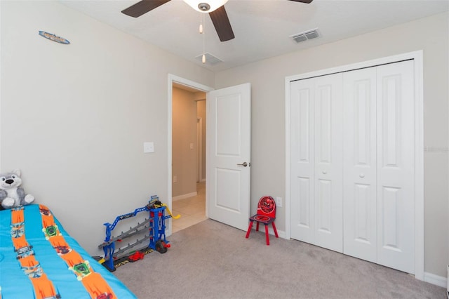 unfurnished bedroom featuring a ceiling fan, a closet, visible vents, and carpet flooring