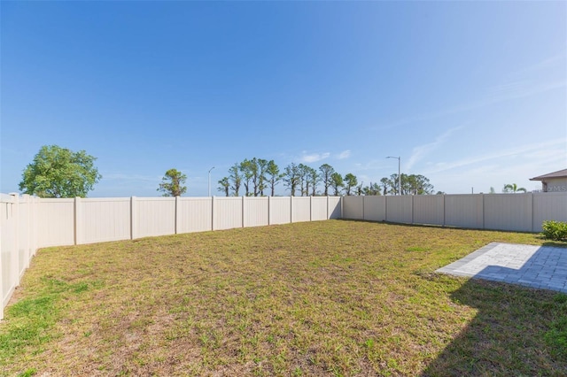 view of yard featuring a patio area and a fenced backyard