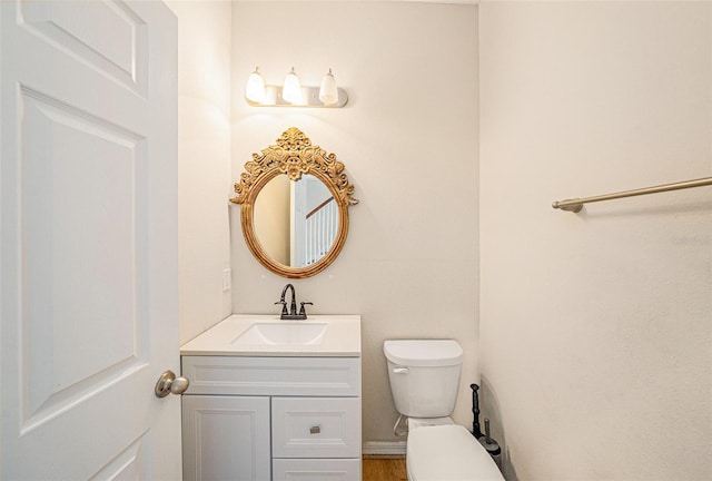 bathroom featuring toilet and vanity