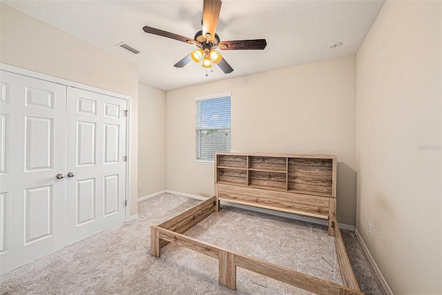 bedroom featuring ceiling fan, carpet, visible vents, and baseboards