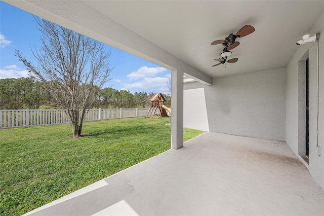 view of yard featuring a patio area, a playground, a fenced backyard, and ceiling fan