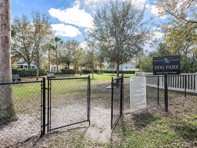 view of gate featuring a lawn and fence