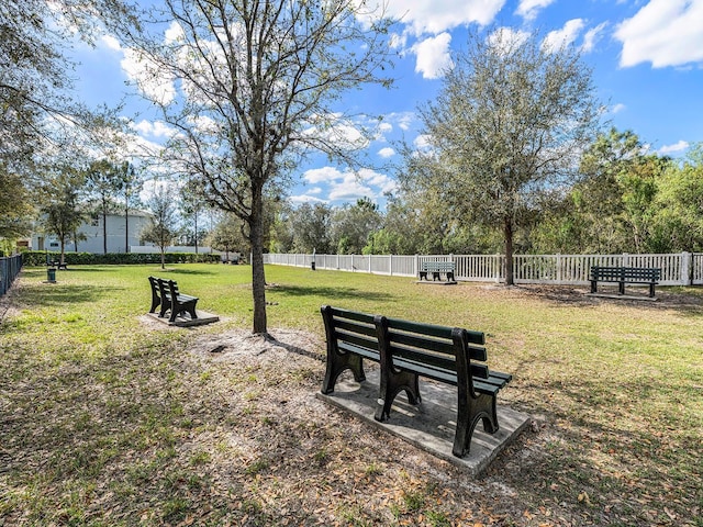 surrounding community with a yard and fence