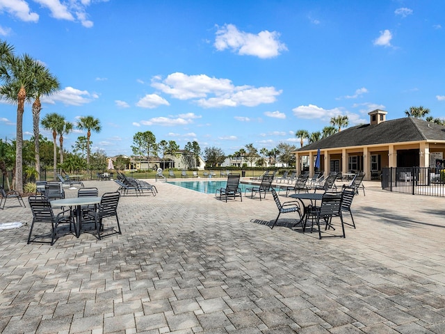 community pool featuring a patio and fence