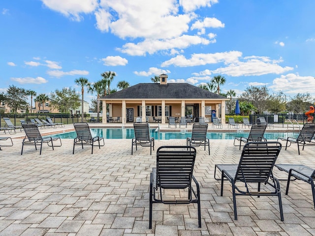 pool featuring a patio area and fence