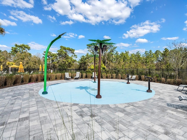 view of home's community featuring a swimming pool, fence, and a patio