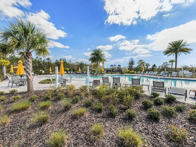 community pool with fence and a patio