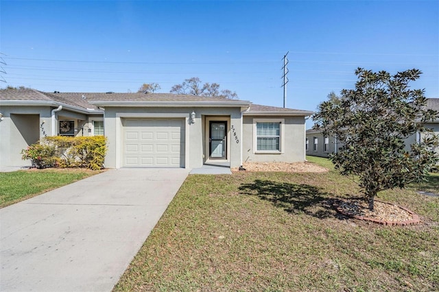 single story home featuring an attached garage, stucco siding, concrete driveway, and a front yard